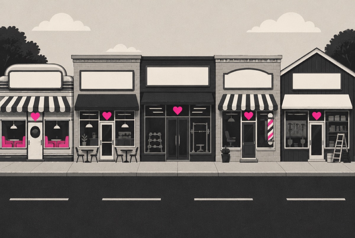 Five local storefronts on a small-town main street, each with a pink heart above the door